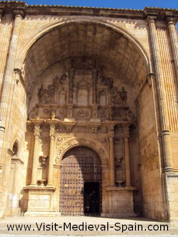 The ornately carved main entrance to the cathedral of Alarcon, Spain