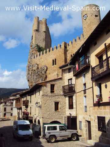 The medieval castle of Frias perched precariously above the village's timbered houses