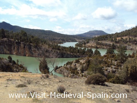 Landscape photo showing the River Jucar surrounded by trees and mountains near to Alarcon, Spain