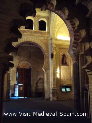 Photo of the painted interior of the San Roman Church, Toledo. The photo is slightly blurred due to low light but shows the rich decorations of this church which is now a Visigoth museum.