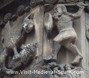 Stone carving on the facade of Barcelona's 13th Century Medieval Cathedral showing the Catalan hero Wilfred the Hairy killing a dragon 