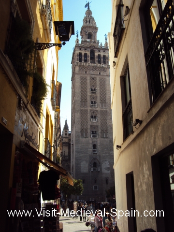 View down a narrow alley to the Giralda Tower, Seville