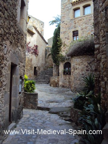 Cobbled streets winding between the medieval houses in Pals Northern Spain.