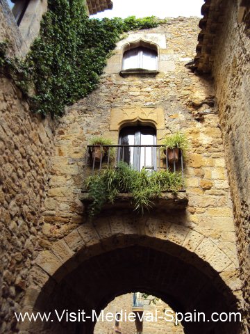 Typical stone arches and balconies of medieval houses in Spain.